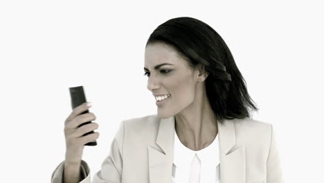 Businesswoman-screaming-down-her-mobile-phone-in-black-and-white