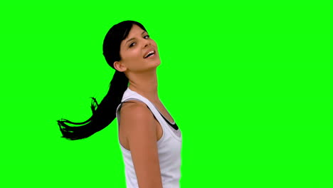 Athletic-woman-tossing-her-hair-against-green-screen