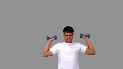 Man-lifting-dumbbells-on-grey-screen