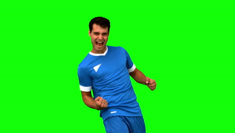 Cheerful-football-player-gesturing-on-green-screen