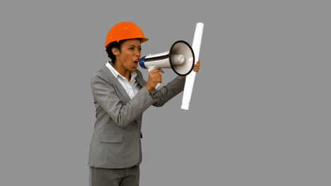 Angry-architect-using-a-megaphone-on-grey-screen