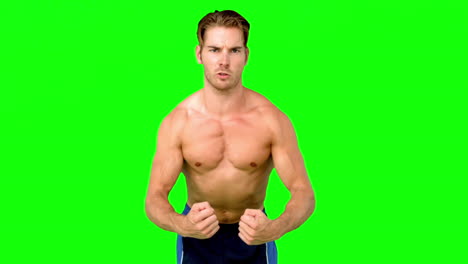 Hombre-Serio-Sin-Camisa-Flexionando-Los-Músculos