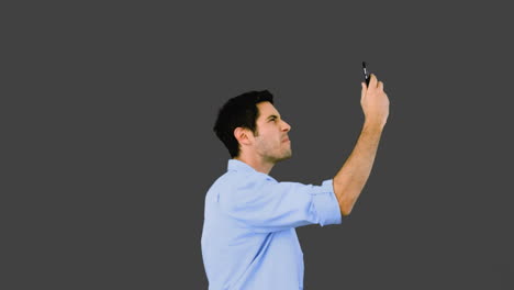 Angry-man-talking-on-phone-and-throwing-it-away-on-grey-background