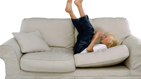 Young-boy-jumping-on-the-sofa-on-white-background