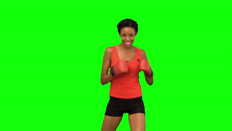 Woman-performing-air-kick-on-green-screen