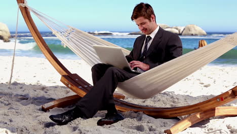 Businessman-typing-on-his-laptop-in-a-hammock