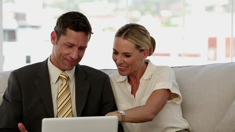 Laughing-colleagues-looking-at-a-laptop