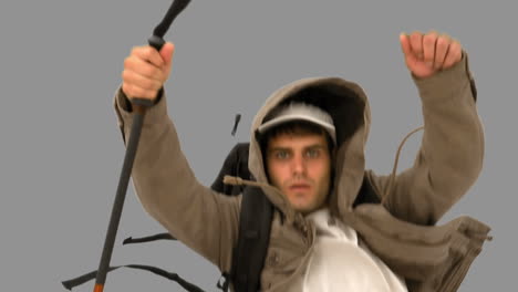 Man-with-a-hiking-stick-running-on-grey-screen