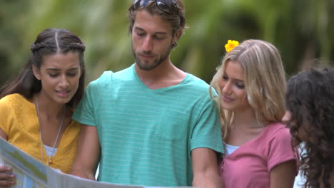 Friends-reading-a-map-and-smiling