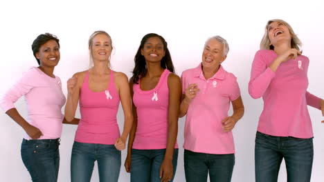 Women-wearing-pink-ribbon-against-cancer-dancing