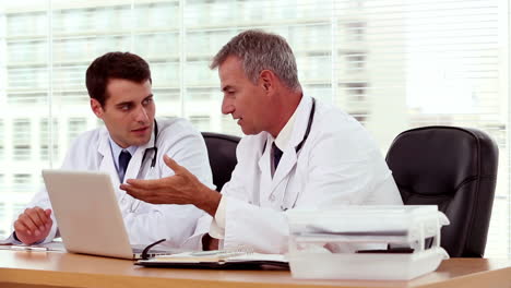Doctor-showing-and-explaining-something-to-his-colleague-