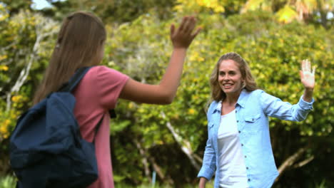 Mother-and-daughter-saying-goodbye-to-each-other-