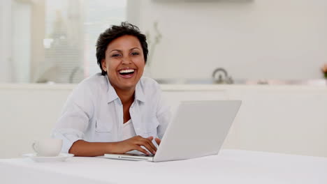 Woman-typing-on-laptop-and-listening-to-music