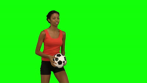 Woman-juggling-a-football-on-green-screen