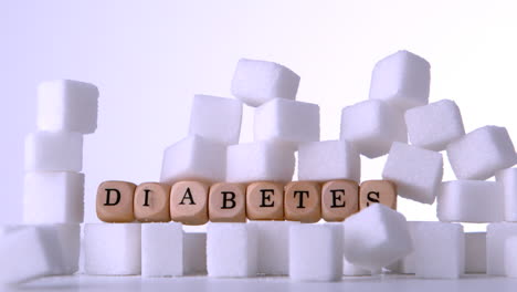 Sugar-cubes-falling-in-front-of-wood-dice-spelling-out-diabetes