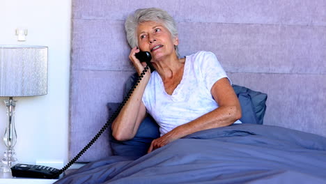 Woman-in-bed-talking-on-the-phone
