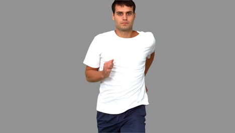 Handsome-man-jogging-on-grey-screen