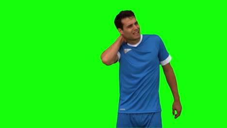 Football-player-suffering-from-neck-pain-on-green-screen