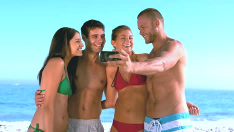 Group-of-friends-taking-self-pictures-on-the-beach