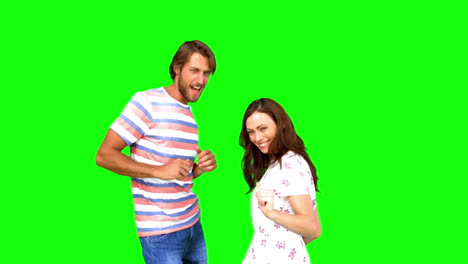 Two-friends-dancing-together-on-green-screen