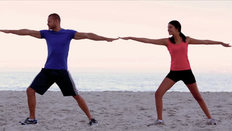 Friends-stretching-on-the-beach-together