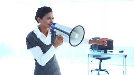 Outraged-businesswoman-screaming-in-a-megaphone-