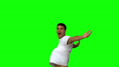 Handsome-man-turning-and-raising-arms-on-green-screen