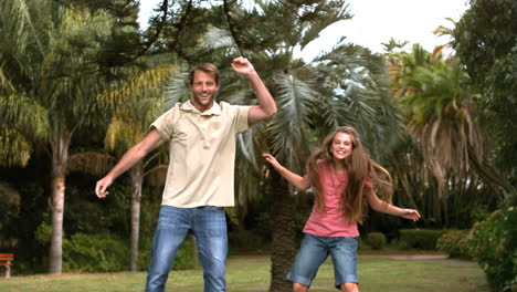 Happy-father-jumping-on-a-trampoline-with-his-daughter-