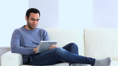 Man-using-a-tablet-on-the-couch