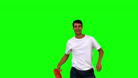 Man-catching-a-frisbee-on-green-screen