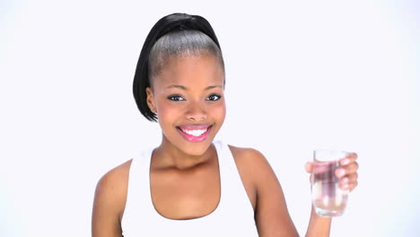 Cheerful-model-in-sportswear-drinking-water