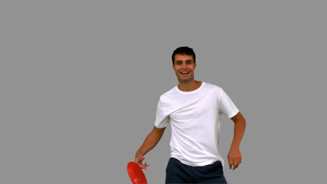 Man-catching-a-frisbee-on-grey-screen