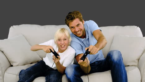 Father-and-son-playing-video-games-on-grey-background-