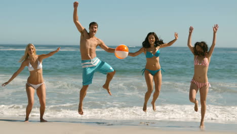 Happy-friends-jumping-and-playing-on-the-beach