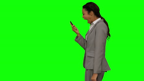 Angry-woman-shouting-at-her-phone-on-green-screen
