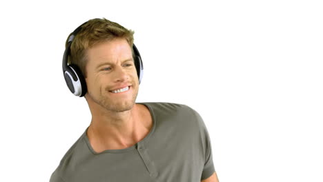 Attractive-man-with-headphones-listening-to-music-on-white-background