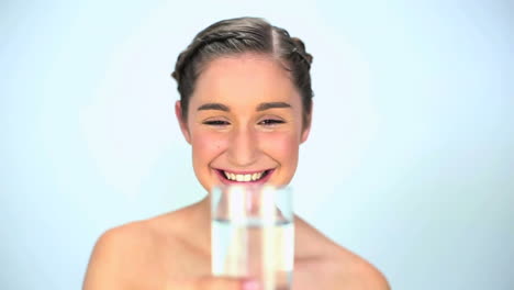 Smiling-young-woman-drinking-water