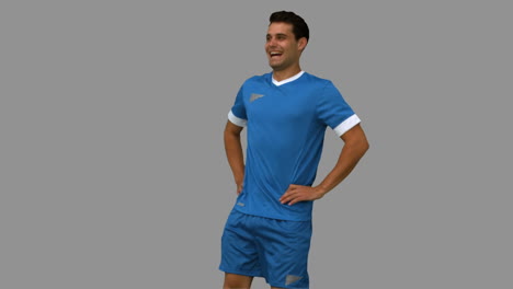 Football-player-warming-up-on-grey-screen