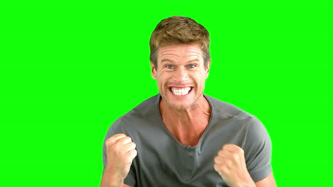 Attractive-man-gesturing-and-showing-his-happiness-on-green-screen-