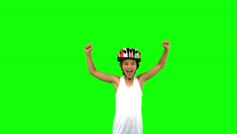 Cute-girl-wearing-a-bike-helmet-and-raising-arms-on-green-screen