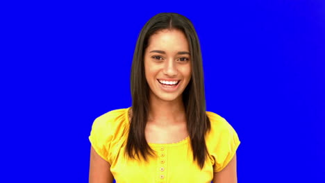 Confused-woman-being-surprised-then-laughing-on-blue-screen
