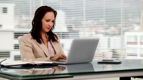 Businesswoman-typing-on-her-laptop