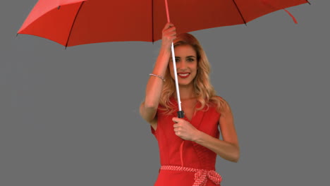 Woman-holding-an-umbrella-on-grey-screen