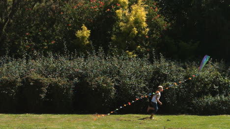 Siblings-having-fun-in-a-park-with-a-kite