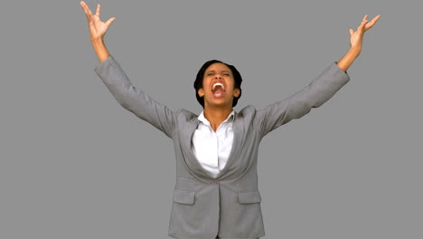 Angry-businesswoman-raising-arms-on-grey-screen