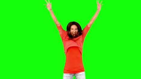 Woman-jumping-with-arms-raised-on-green-screen