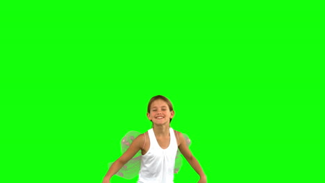 Girl-wearing-dragonfly-wings-and-jumping-on-green-screen