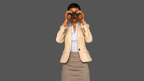 Astonished-businesswoman-holding-binoculars