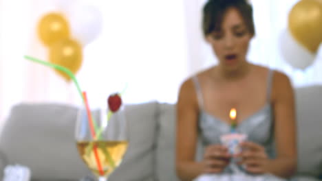 Woman-blowing-out-candles