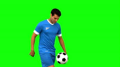 Handsome-man-playing-with-a-football-on-green-screen